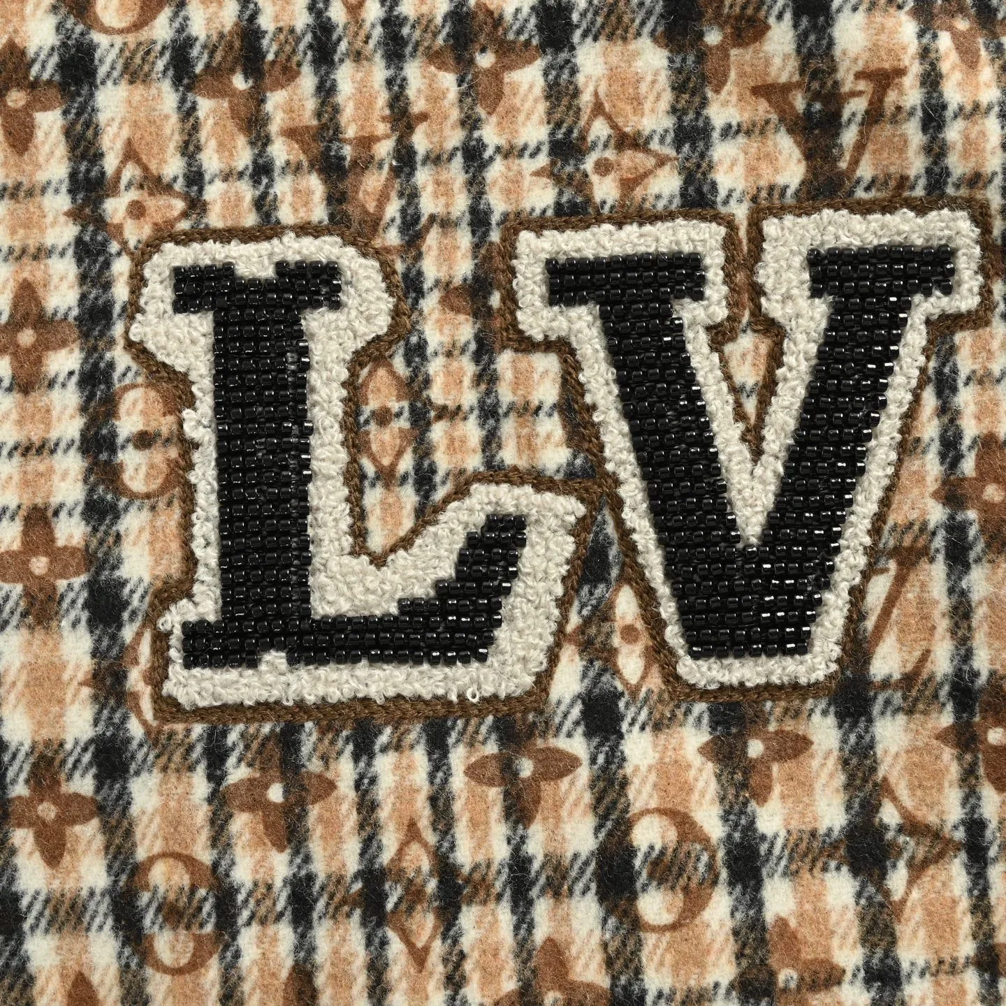 Louis Vuitton jacket with embroidered badges and all-over monogram print.